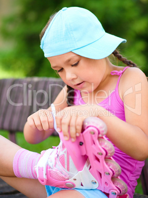 Little girl is wearing roller-blades