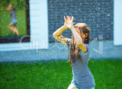 Happy girl is playing under rain