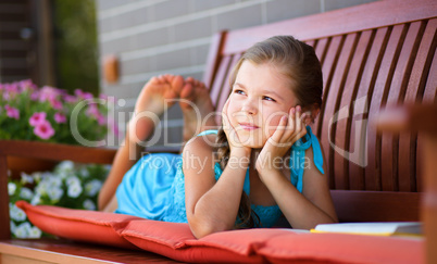 Little girl is reading a book