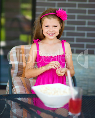 Little girl is drinking cherry juice