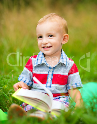 Little boy is reading book