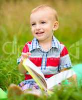 Little boy is reading book