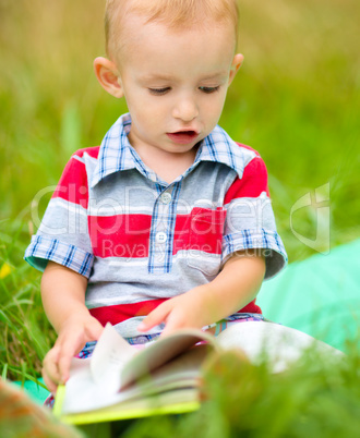 Little boy is reading book