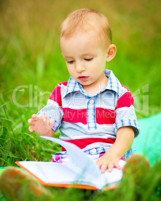 Little boy is reading book