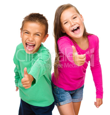 Little boy and girl are showing thumb up sign