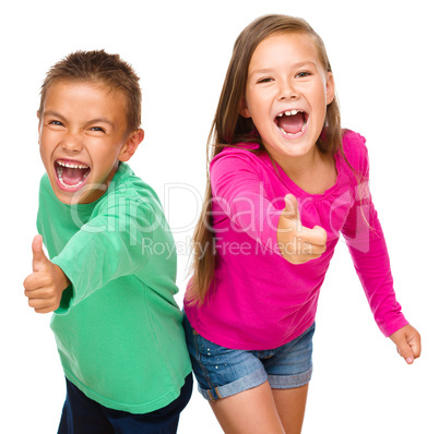 Little boy and girl are showing thumb up sign