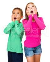Little girl and boy are holding their faces