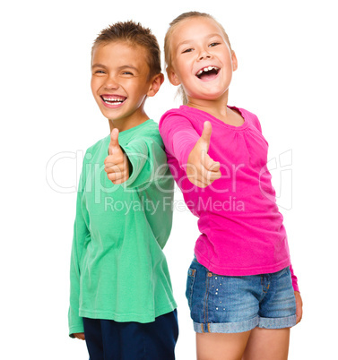 Little boy and girl are showing thumb up sign