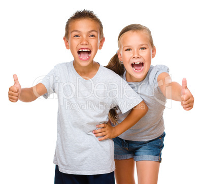 Little boy and girl are showing thumb up sign