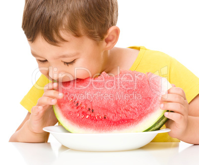 Little boy is eating watermelon