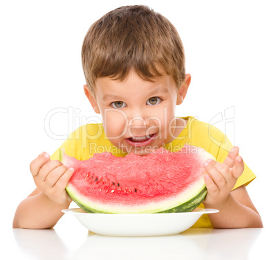 Little boy is eating watermelon