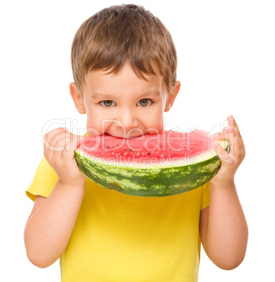 Little boy is eating watermelon