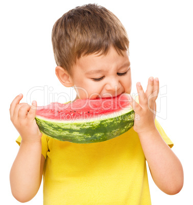 Little boy is eating watermelon