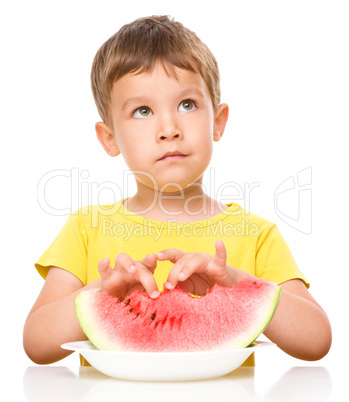 Little boy is eating watermelon