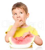 Little boy is eating watermelon