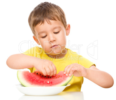 Little boy is eating watermelon