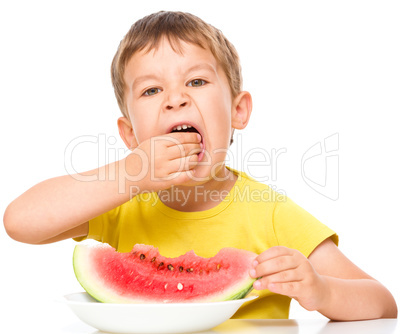 Little boy is eating watermelon