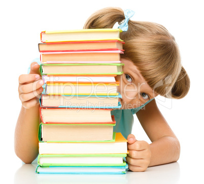 Little girl plays with book