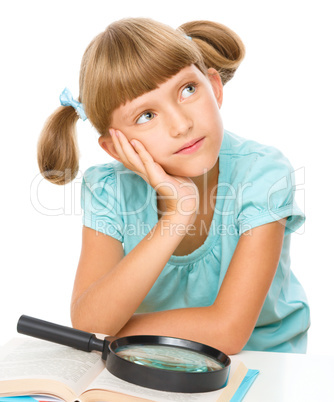 Little girl is reading book