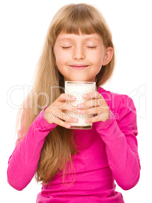 Happy little girl with a glass of milk