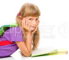 Little girl is reading a book