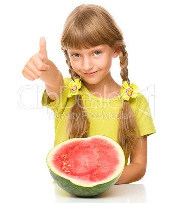 Little girl is eating watermelon