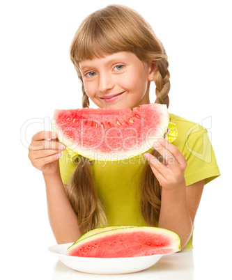 Little girl is eating watermelon