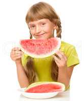 Little girl is eating watermelon