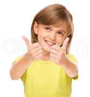 Little girl is showing thumb up sign