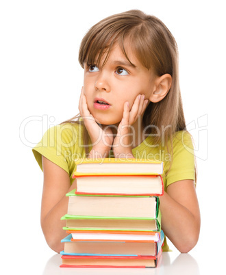 Little girl with a pile of books