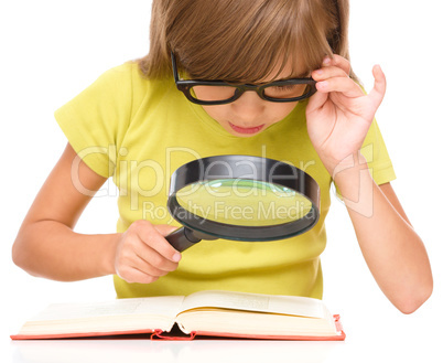 Little girl is reading book