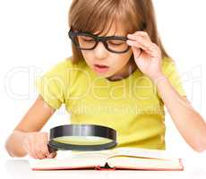Little girl is reading book