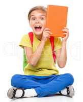 Portrait of a cute little schoolgirl with backpack