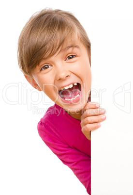 Little girl is looking out from the blank banner