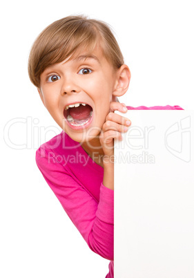 Little girl is looking out from the blank banner