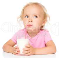 Cute little girl with a glass of milk