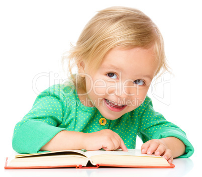 Little girl is reading her book