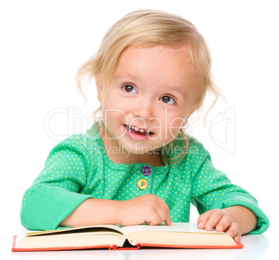 Little girl is reading her book