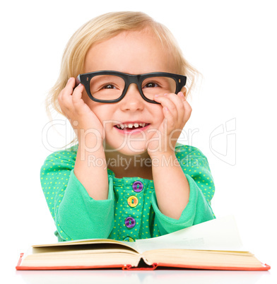 Little girl is reading her book