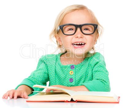 Little girl is reading her book