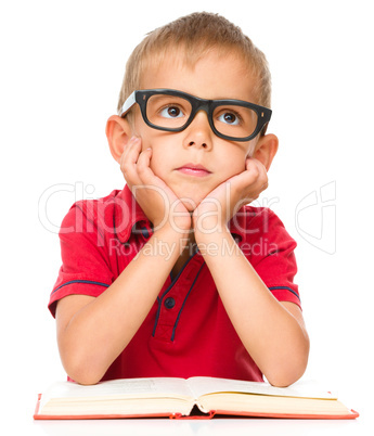 Little boy is reading a book