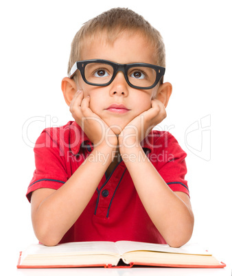 Little boy is reading a book