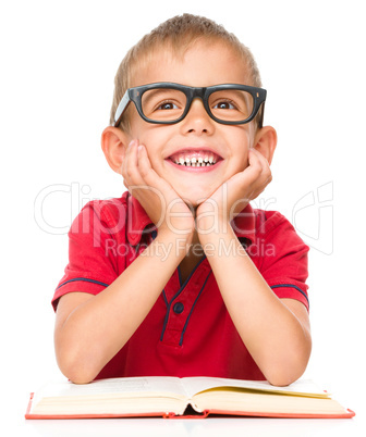 Little boy is reading a book