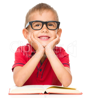 Little boy is reading a book