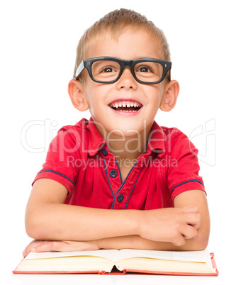 Little boy is reading a book