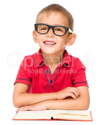 Little boy is reading a book