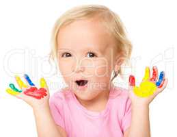 Portrait of a cute little girl playing with paints