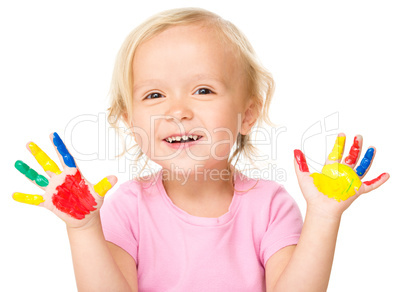 Portrait of a cute little girl playing with paints