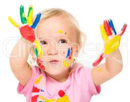 Portrait of a cute little girl playing with paints