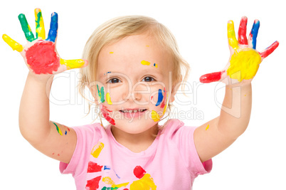 Portrait of a cute little girl playing with paints